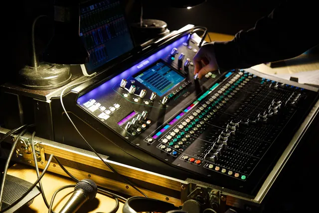 audio and lighting mixing console in a venue