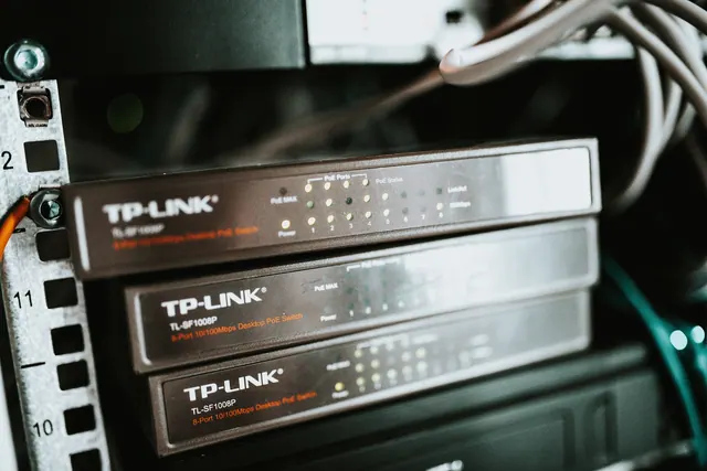 stack of network switches with status LEDs in a rack