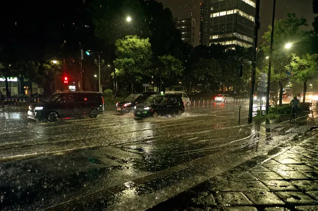 Tokyo Tower seen from a wet street in evening rain